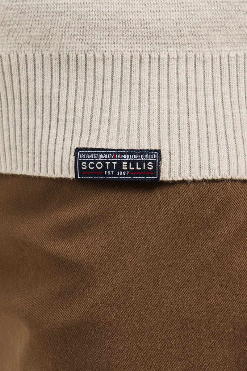 Le chandail en tricot de coton col montant avec fermeture éclair